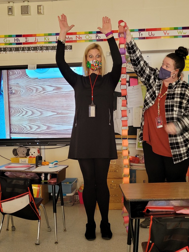 Ms. Thomson's class paper chain measured next to Mrs. Hallissey.