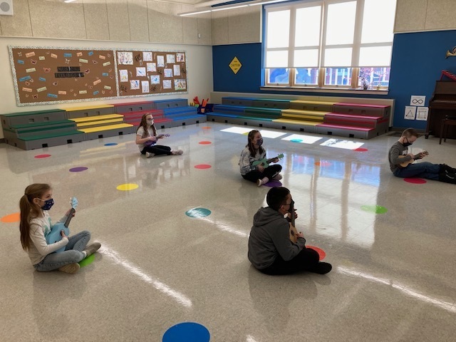 Mrs. Morton's 4th grad students learning to play notes on a ukulele.