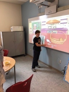 Student using interactive whiteboard in classroom